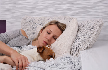 Woman and dog sleeping together. Pet Allergies concept