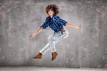 Obraz na płótnie Canvas Young girl dancing, jumping.