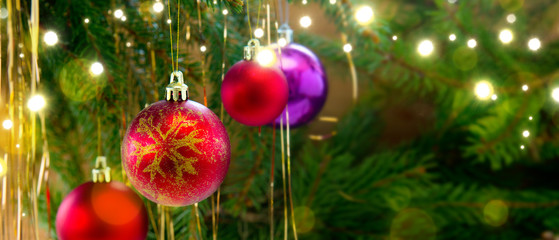 Fototapeta na wymiar Colorful christmas balls isolated on green fir tree background.