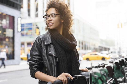 Woman standing at bicycle rack