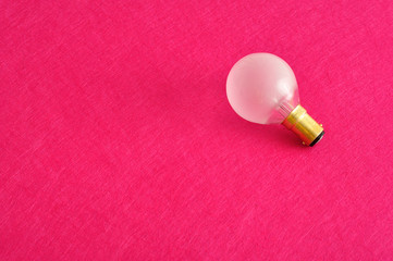 A light bulb isolated on a pink background