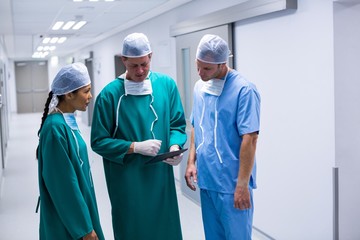 Surgeons having discussion over digital tablet 