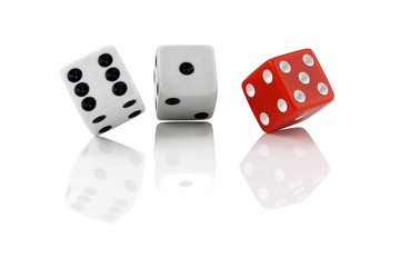 trio of dice on reflected background