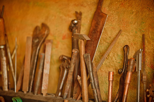 Different metal worker tools on wooden table