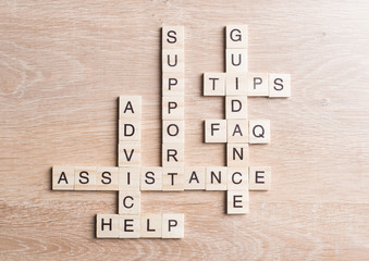 Conceptual media keywords on table with elements of game making crossword