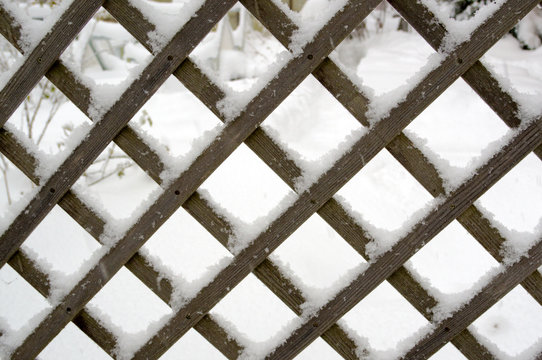 wooden lattice covered with snow