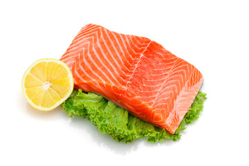 Fresh raw salmon fillet with lime and lemon isolated on white background