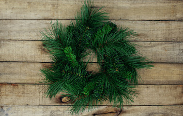 Green fir christmas wreath on wooden background
