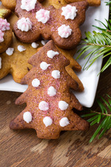Colorful Christmas gingerbread cookies on wooden background
