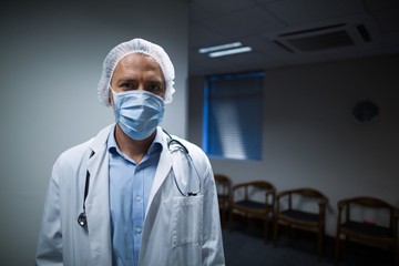 Fototapeta na wymiar Portrait of male doctor standing in corridor
