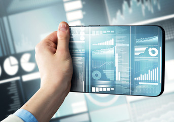 Media technology concept presented by businessman holding tablet with graphs and diagrams