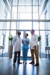 Fototapeta premium Surgeons and nurse interacting with each other