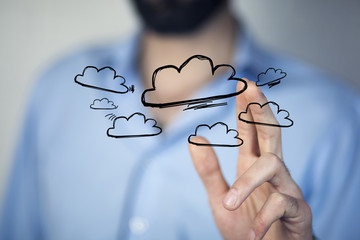 Man working with touch screen- clouds