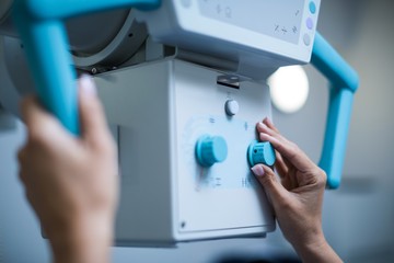 Doctor sets up the machine to x-ray over patient