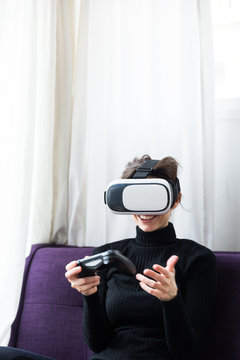 Woman with gamepad and VR set