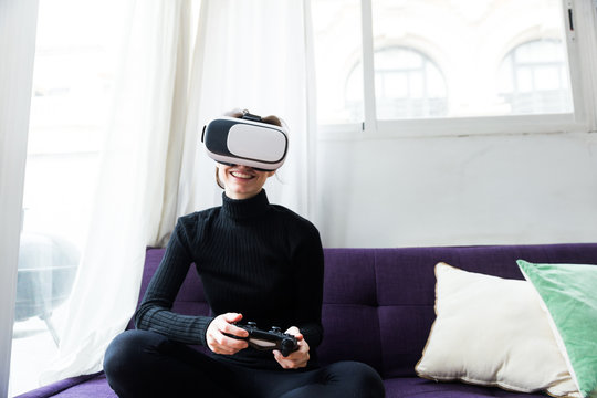 Woman with gamepad and VR set
