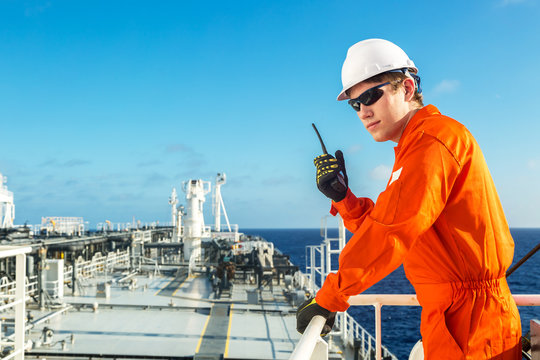 Deck officer using radio on the board of a tanker.