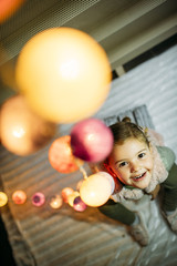 Fototapeta na wymiar Little girl decorating home for Christmas