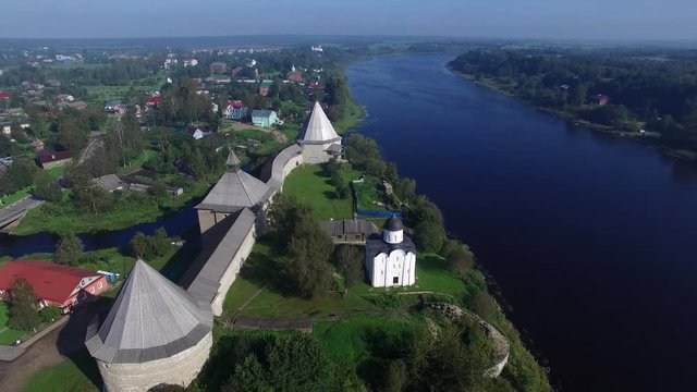 Flying over the ancient fortress in Staraya Ladoga on the banks of the river Volhov. Aerial view.