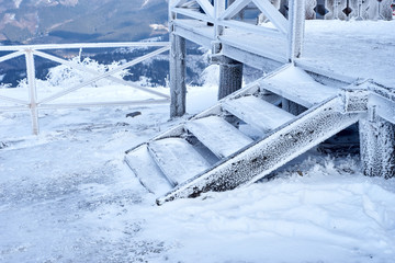 wooden staircase in the mountains in winter