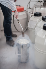 Liquid nitrogen technician fills cryogenic container