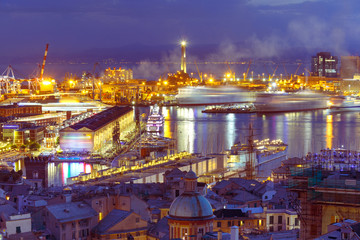Naklejka premium Historical Lanterna old Lighthouse, container and passenger terminals in seaport of Genoa on Mediterranean Sea, at night, Italy.