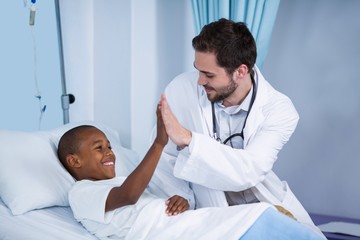 Doctor and patient giving high five