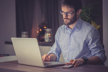 Man working on a laptop at night