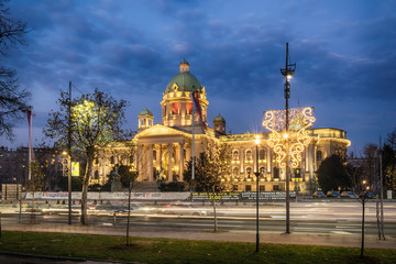 Belgrade, Serbia - December 11, 2016:  Parliament of the Republic of Serbia in Belgrade at night. The building of the National Assembly, originally the House of Commons, began to be built in 1907. - obrazy, fototapety, plakaty