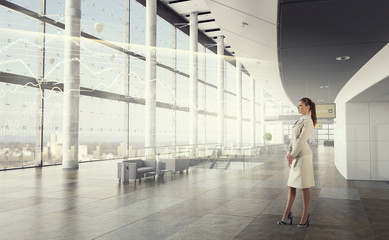 Businesswoman in her office . Mixed media