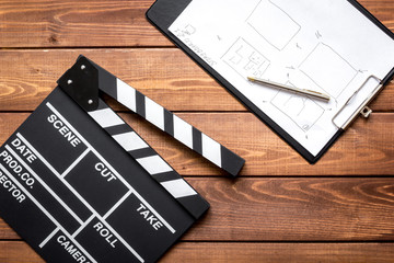 Work screenwriter on wooden background top view