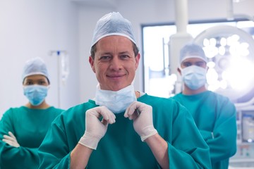 Team of surgeons wearing surgical mask in operation theater