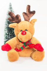 Reindeer doll with Christmas tree on white background.