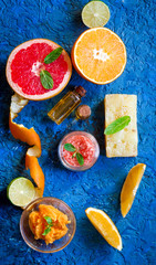 organic cosmetic with citrus on blue background top view