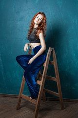 Red-haired woman fashion model posing for the advertising.