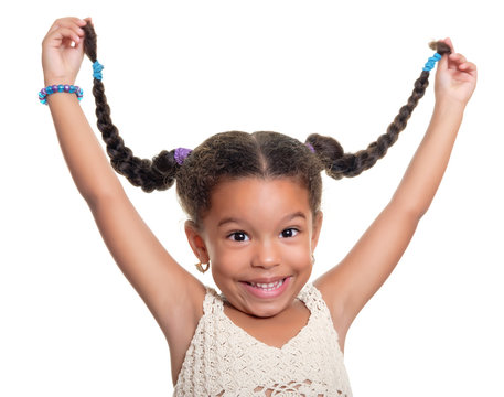 Cute African American Small Girl Laughing And Pulling Her Hair In The Air