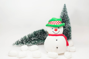 Snowman doll and christmas tree on white background.