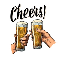 Female and male hands holding and clinking with two glasses beer