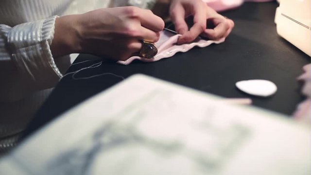 Woman dressmaker sews a bra. Handmade work