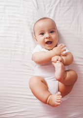 Portrait of a baby lying on the bed