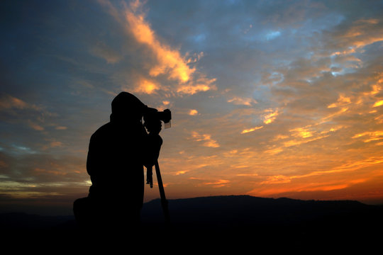 silhouette of a photographer taking pictures