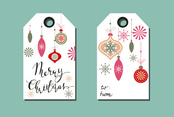 tags with Christmas decorations on light background