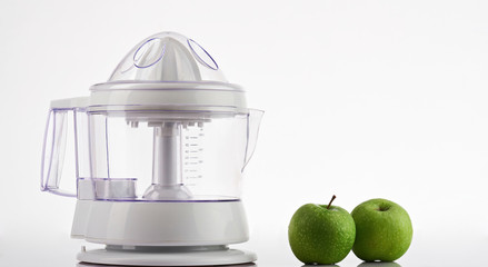 Two green apples with juicer