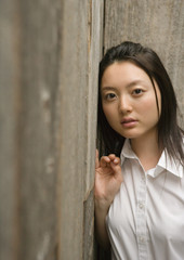 Teenage girl leaning against wall
