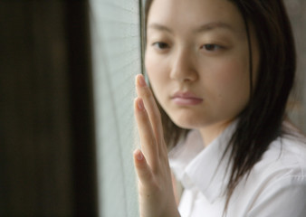 Girl by window in school uniform