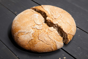 Homemade bread on a black wooden background