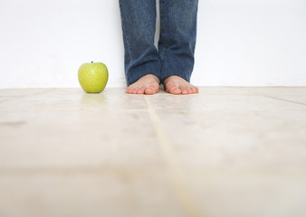 Woman's barefoot and green apple