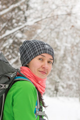 Portrait of an Asian girl backpacker in the winter forest