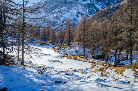 Frozen Lago Blu basked in afternoon light, Valtournenche, Aosta Valley