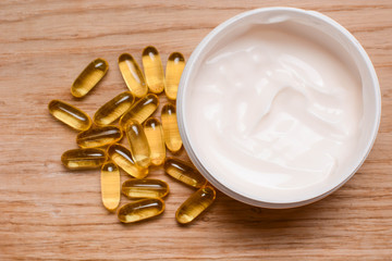 Set of care cream and Fish oil capsules with omega 3 and vitamin D. Beauty and health concept